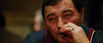 Movie still from “Rounders” (1998), directed by John Dahl – A person smoking a cigarette; Close Up shot, Low angle