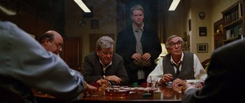 Movie still from “Rounders” (1998), directed by John Dahl – A group of people sitting at a table with drinks; Medium shot, Over the shoulder angle