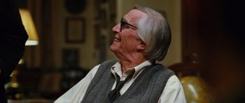 Movie still from “Rounders” (1998), directed by John Dahl – An older man wearing glasses and a tie; Close Up shot, Over the shoulder angle