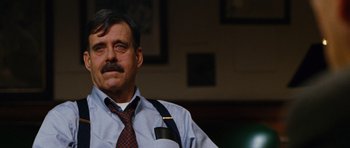 Movie still from “Rounders” (1998), directed by John Dahl – An older man wearing a neck tie and suspenders; Close Up shot, Low angle