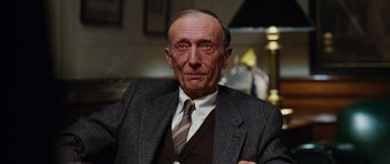 Movie still from “Rounders” (1998), directed by John Dahl – An older man wearing a suit and tie; Close Up shot, Low angle