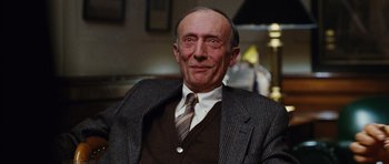Movie still from “Rounders” (1998), directed by John Dahl – An older man wearing a suit and tie; Close Up shot, Low angle
