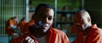Movie still from “Rounders” (1998), directed by John Dahl – A man in an orange jacket is holding a pipe in his mouth; Close Up shot, Low angle