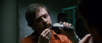 Movie still from “Rounders” (1998), directed by John Dahl – A man is shaving his beard with an electric shaver; Close Up shot, Over the shoulder angle