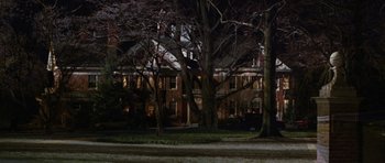 Movie still from “Rounders” (1998), directed by John Dahl – A house with a large tree in front of it at night time; Extreme Wide shot, Low angle
