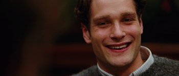 Movie still from “Rounders” (1998), directed by John Dahl – A man smiling for the camera; Close Up shot, High angle