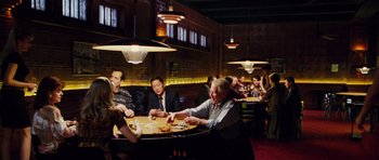 Movie still from “Rounders” (1998), directed by John Dahl – A group of people sitting at a table playing cards; Wide shot, High angle