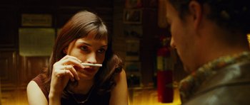 Movie still from “Rounders” (1998), directed by John Dahl – A woman sitting in front of a man holding a toothbrush; Close Up shot, Over the shoulder angle