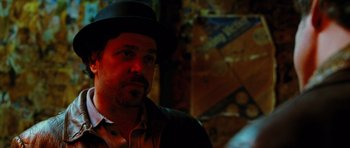 Movie still from “Rounders” (1998), directed by John Dahl – A person wearing a hat; Close Up shot, Over the shoulder angle