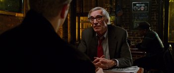 Movie still from “Rounders” (1998), directed by John Dahl – An older man wearing a suit and tie talking to a younger man; Close Up shot, Over the shoulder angle