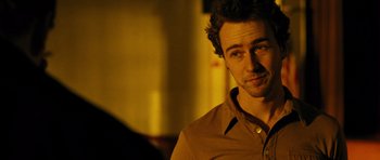 Movie still from “Rounders” (1998), directed by John Dahl – A person wearing a brown shirt; Close Up shot, Over the shoulder angle