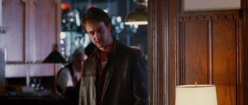 Movie still from “Rounders” (1998), directed by John Dahl – A man wearing a leather jacket standing in a room; Close Up shot, Over the shoulder angle