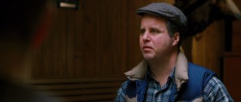 Movie still from “Rounders” (1998), directed by John Dahl – A man wearing a hat and a jacket; Close Up shot, Over the shoulder angle