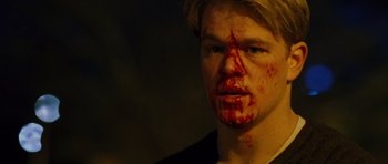Movie still from “Rounders” (1998), directed by John Dahl – A man with blood all over his face; Close Up shot, Low angle