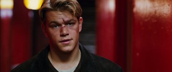 Movie still from “Rounders” (1998), directed by John Dahl – A person with a bandage on his face; Close Up shot, Over the shoulder angle