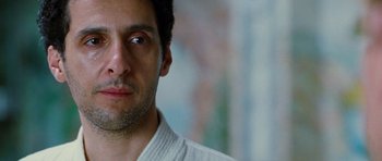 Movie still from “Rounders” (1998), directed by John Dahl – A person wearing a white shirt; Close Up shot, Low angle