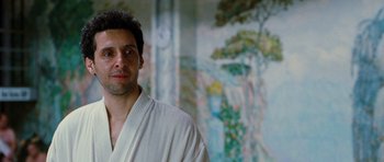 Movie still from “Rounders” (1998), directed by John Dahl – A man in a robe standing in front of a painting; Close Up shot, Low angle