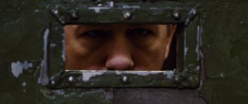 Movie still from “Rounders” (1998), directed by John Dahl – A person looking through a fence; Close Up shot, Low angle