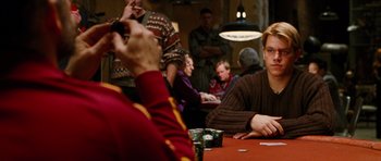 Movie still from “Rounders” (1998), directed by John Dahl – A group of people sitting at a table playing a game; Medium shot, Over the shoulder angle