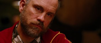 Movie still from “Rounders” (1998), directed by John Dahl – A person with a beard; Close Up shot, Over the shoulder angle