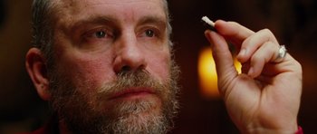 Movie still from “Rounders” (1998), directed by John Dahl – A person with a beard; Close Up shot, Over the shoulder angle