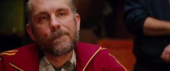 Movie still from “Rounders” (1998), directed by John Dahl – A person with a beard wearing a jacket; Close Up shot, Over the shoulder angle