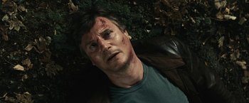 Movie still from “Run All Night” (2015), directed by Jaume Collet-Serra – A person laying on the ground with blood all over his face; Close Up shot, Low angle