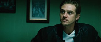 Movie still from “Run All Night” (2015), directed by Jaume Collet-Serra – A person wearing a leather jacket; Close Up shot, Low angle