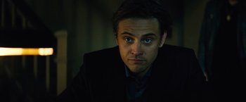 Movie still from “Run All Night” (2015), directed by Jaume Collet-Serra – A person wearing a suit and tie; Close Up shot, Low angle