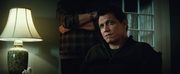 Movie still from “Run All Night” (2015), directed by Jaume Collet-Serra – A man in a black jacket and a man in a plaid shirt; Close Up shot, Low angle