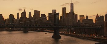 Movie still from “Run All Night” (2015), directed by Jaume Collet-Serra – A view of a bridge and a city at sunset; Extreme Wide shot, High angle
