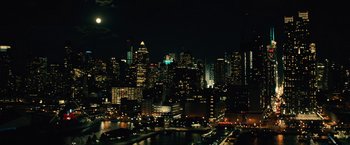 Movie still from “Run All Night” (2015), directed by Jaume Collet-Serra – A view of a city at night with a full moon in the background; Extreme Wide shot, High angle