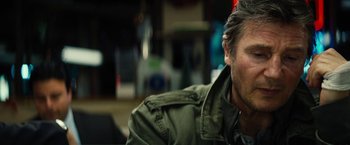 Movie still from “Run All Night” (2015), directed by Jaume Collet-Serra – A person wearing a green jacket; Close Up shot, Over the shoulder angle