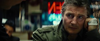 Movie still from “Run All Night” (2015), directed by Jaume Collet-Serra – A person wearing a green jacket; Close Up shot, Low angle