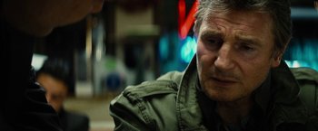 Movie still from “Run All Night” (2015), directed by Jaume Collet-Serra – A person wearing a green jacket; Close Up shot, Over the shoulder angle