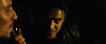 Movie still from “Run All Night” (2015), directed by Jaume Collet-Serra – A person's face in the dark; Close Up shot, Over the shoulder angle