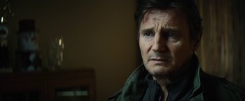 Movie still from “Run All Night” (2015), directed by Jaume Collet-Serra – A person wearing a jacket; Close Up shot, Over the shoulder angle