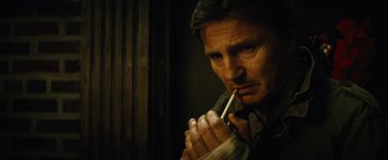 Movie still from “Run All Night” (2015), directed by Jaume Collet-Serra – A person smoking a cigarette; Close Up shot, Low angle