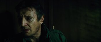 Movie still from “Run All Night” (2015), directed by Jaume Collet-Serra – A person wearing a green jacket; Close Up shot, Low angle