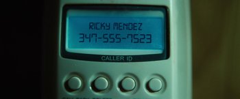 Movie still from “Run All Night” (2015), directed by Jaume Collet-Serra – A phone number on the screen; Extreme Close Up shot, Overhead angle
