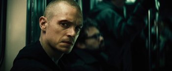 Movie still from “Run All Night” (2015), directed by Jaume Collet-Serra – A person with a bald head; Close Up shot, Low angle