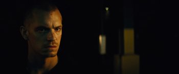 Movie still from “Run All Night” (2015), directed by Jaume Collet-Serra – A person in a dark room; Close Up shot, Low angle