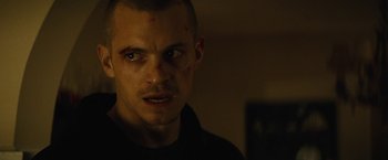 Movie still from “Run All Night” (2015), directed by Jaume Collet-Serra – A person wearing a black shirt; Close Up shot, Low angle