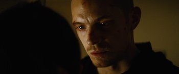 Movie still from “Run All Night” (2015), directed by Jaume Collet-Serra – A person with a bruise on his face; Close Up shot, Low angle