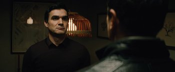 Movie still from “Run All Night” (2015), directed by Jaume Collet-Serra – A man standing in front of a mirror looking at himself in the mirror; Close Up shot, Over the shoulder angle