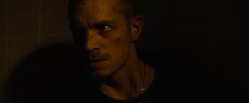 Movie still from “Run All Night” (2015), directed by Jaume Collet-Serra – A person wearing a black t - shirt; Close Up shot, Low angle