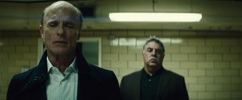 Movie still from “Run All Night” (2015), directed by Jaume Collet-Serra – Two men in suits and ties standing in front of a brick wall; Close Up shot, Low angle