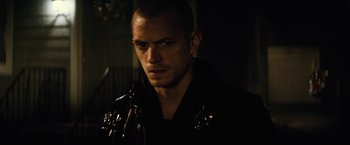 Movie still from “Run All Night” (2015), directed by Jaume Collet-Serra – A person wearing a black jacket; Close Up shot, Low angle