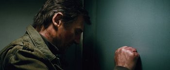 Movie still from “Run All Night” (2015), directed by Jaume Collet-Serra – A person leaning against a wall; Close Up shot, Over the shoulder angle