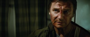 Movie still from “Run All Night” (2015), directed by Jaume Collet-Serra – A person with a face covered in blood; Close Up shot, Low angle